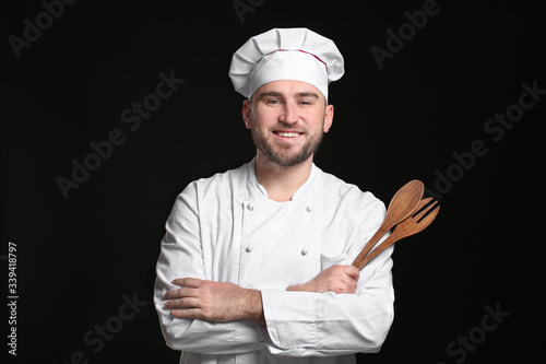 Handsome male chef on dark ...