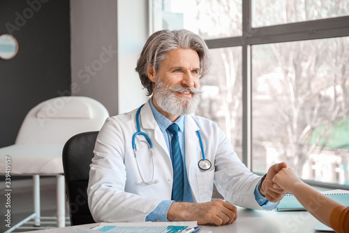 Senior male doctor working ...