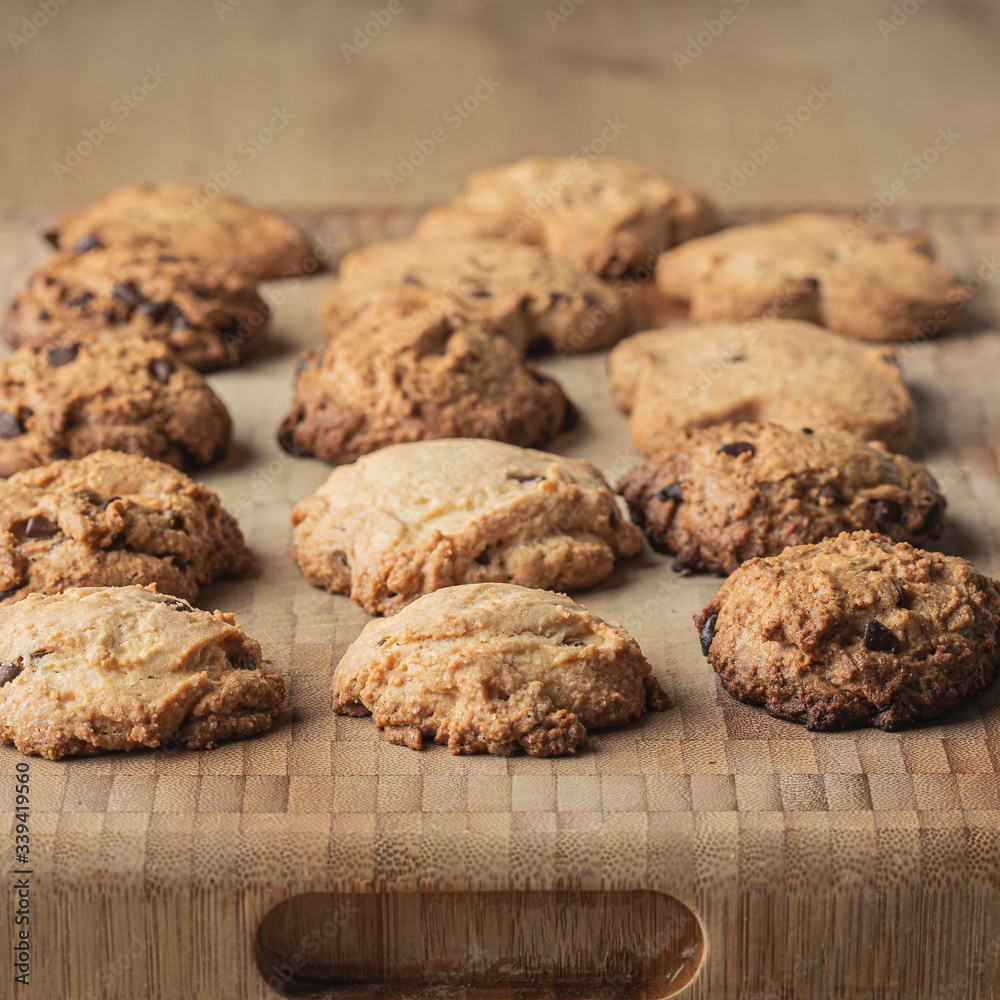 Homemade artisan cookies in a row on a wooden cutting board