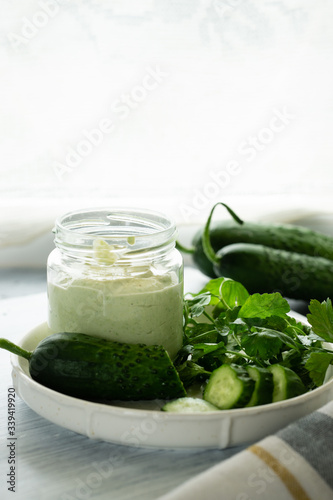 Yogurt with greens and cucumbers for toast for a vitamin spring snack