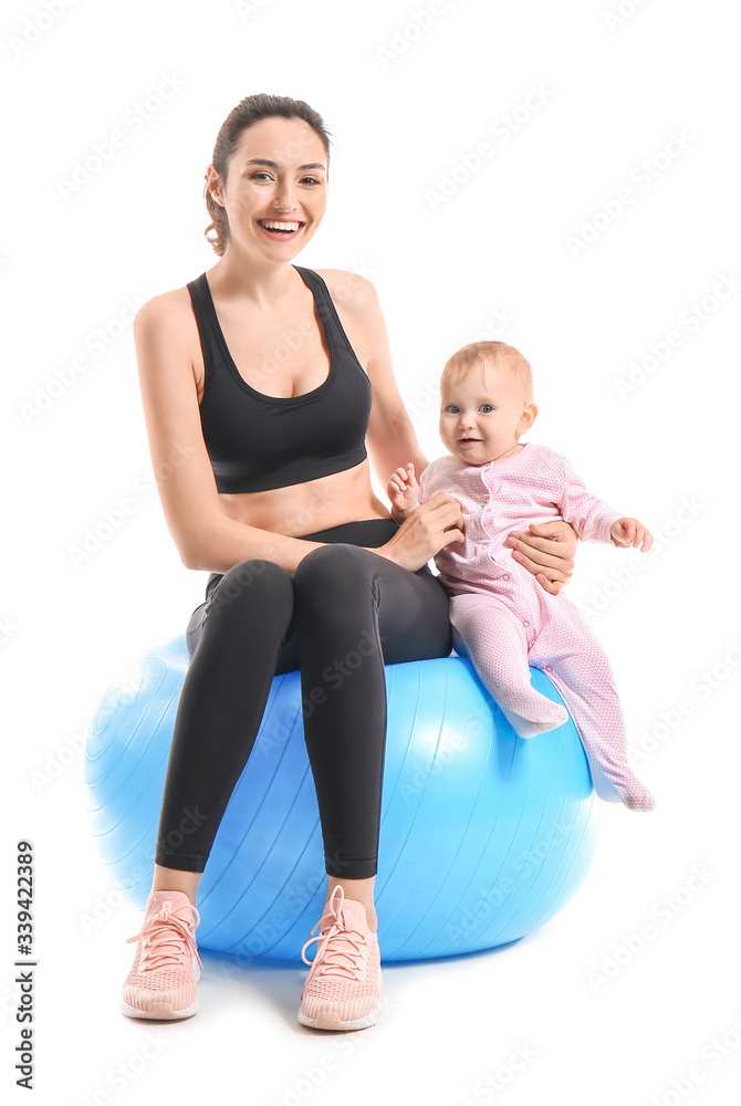 Young sporty mother and her baby doing exercises with fitball on white background Young sporty mother and her baby doing exercises with fitball on white background