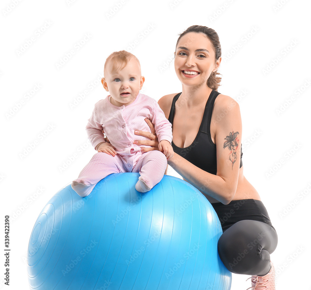 Young sporty mother and her baby doing exercises with fitball on white background Young sporty mother and her baby doing exercises with fitball on white background