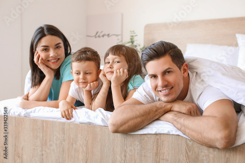 Happy family in bedroom at ...