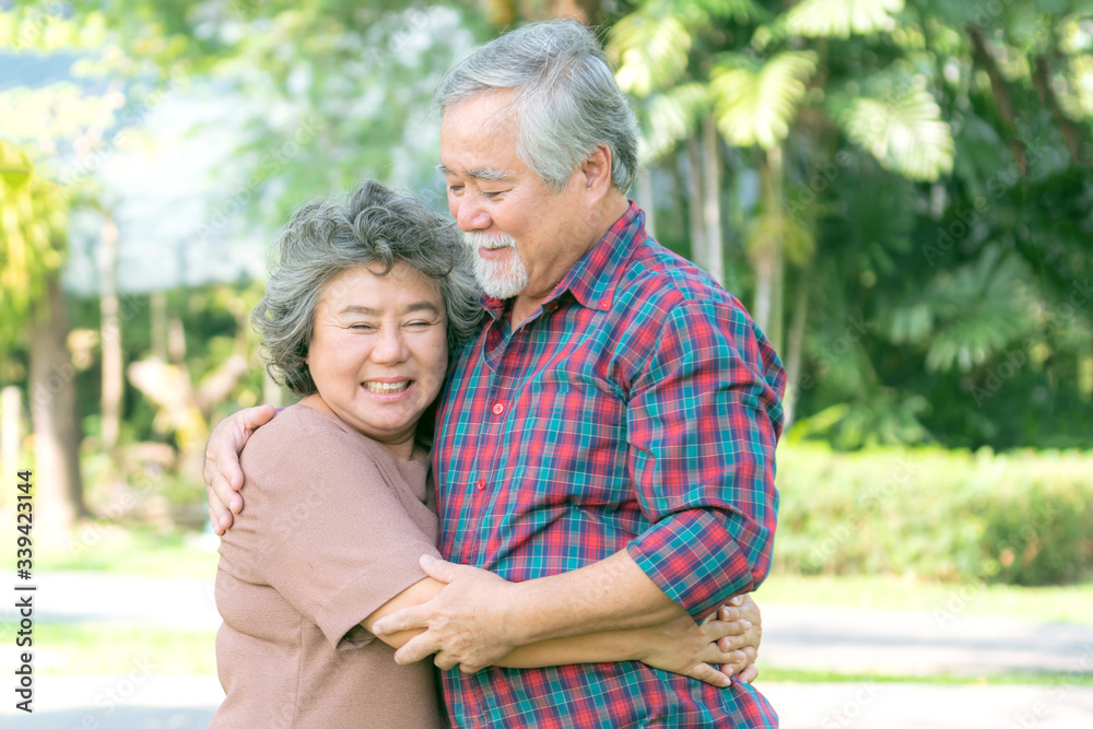 Happy love Elderly couple smile face , Senior couple old man and senior woman relaxing hug in a forest Happy love Elderly couple smile face , Senior couple old man and senior woman relaxing hug in a forest