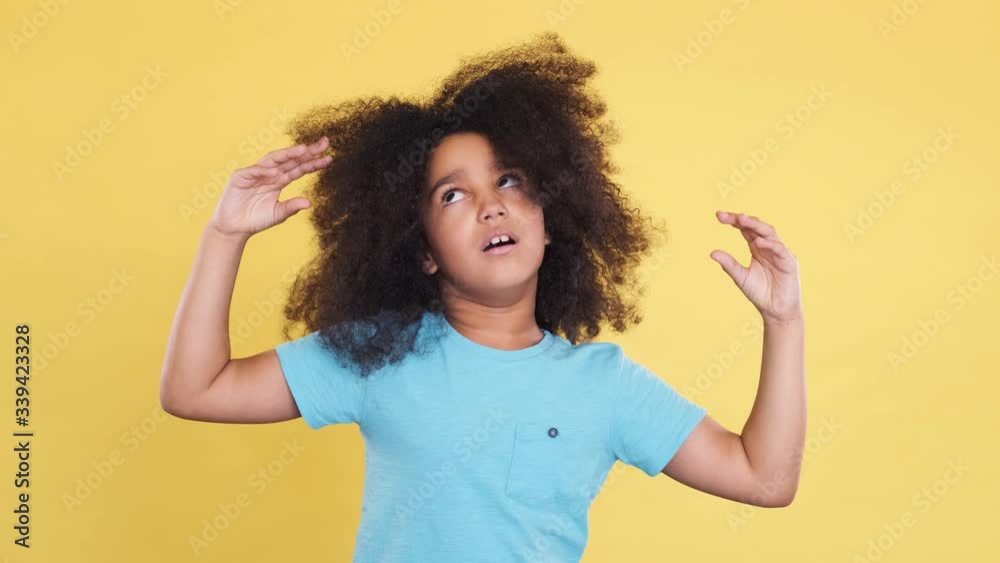 Humorous or Comical Face of Little Latin American Girl with Curly Hair. Funny and Idiotic Facial Expressions. Charismatic and Autistic Kid Have Fun and Shows Grimacing, Gesturing with Hands. Humorous or Comical Face of Little Latin American Girl with Curly Hair. Funny and Idiotic Facial Expressions. Charismatic and Autistic Kid Have Fun and Shows Grimacing, Gesturing with Hands.
