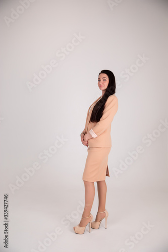 Successful business woman on grey background with copy space. Director in beige suit © fasli