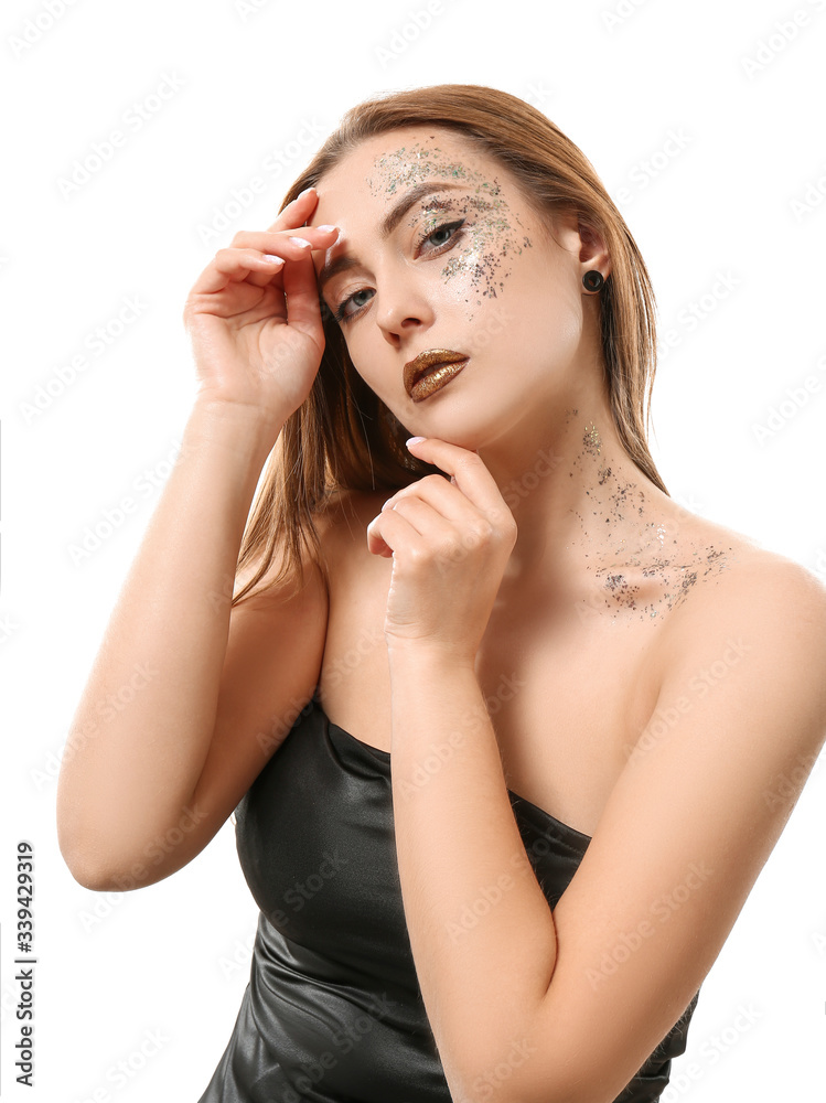 Fashionable young woman with glitters on her body against white background Fashionable young woman with glitters on her body against white background