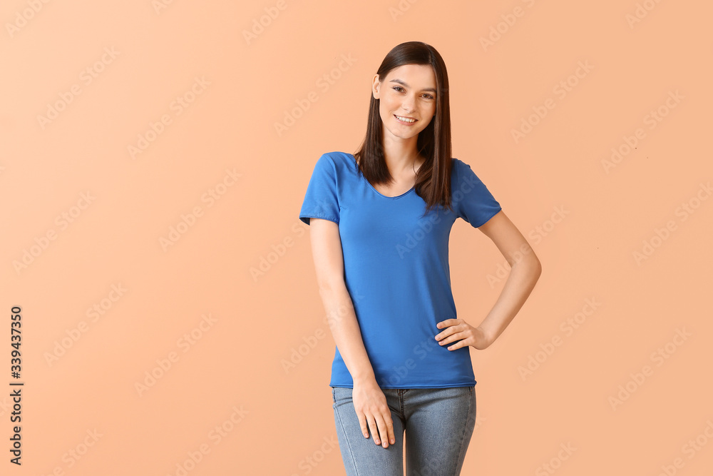 Obraz premium Woman in stylish t-shirt on color background