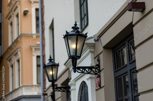 Old fashioned street lamps at night on background old building