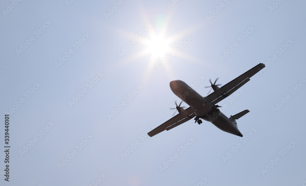 Closeup of an airplane landing to the destination airport with sunny sky background. Closeup of an airplane landing to the destination airport with sunny sky background.