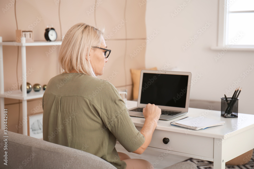 Mature woman using laptop for online learning at home Mature woman using laptop for online learning at home