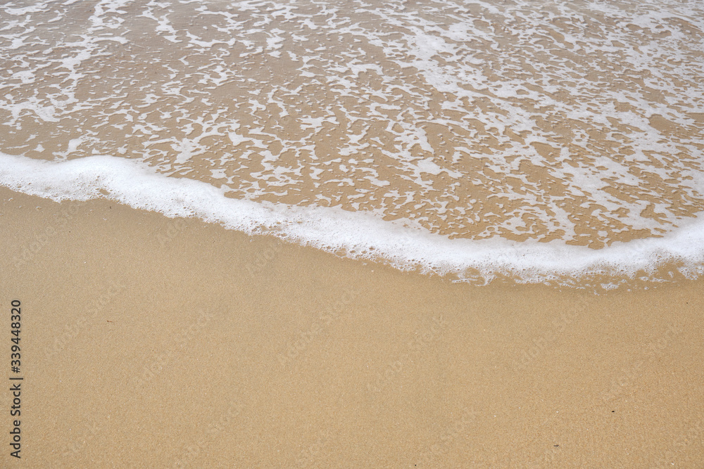 Calm Waves Washing Over a Beach on a Sunny Day