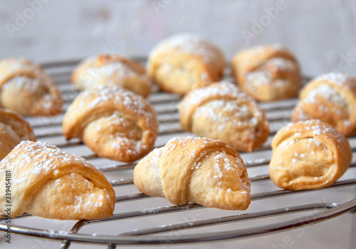 Homemade mini croissants on a cooling rack. Confectionery menu concept