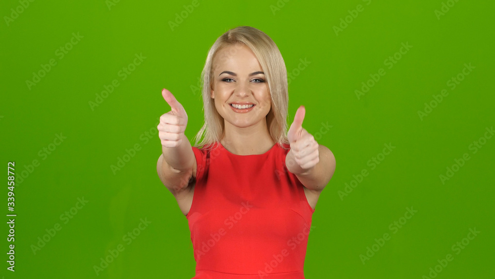 Happy blonde shows gesture all right with both hands. Studio Happy blonde shows gesture all right with both hands. Studio