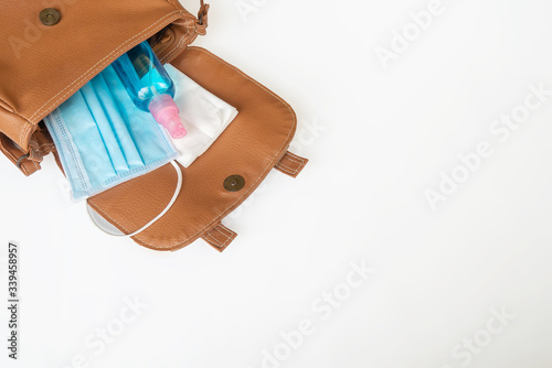 Alcohol spray And a face​ mask Prepared in a portable bag for women when going out. For​ prevent​ Corona​ virus​ or​ Covid-19​ diseases.