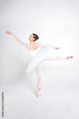 Fototapeta Naklejka Na Ścianę i Meble -  Young ballerina practising ballet moves