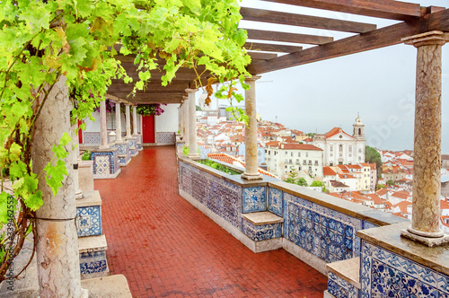 Lisbon. Portugal. Beautiful view of the city, a tourist route along the famous Alfama district. Miradouro de Santa Luzia viewpoint with the Alfama old town and Saint Stephen Church in background.