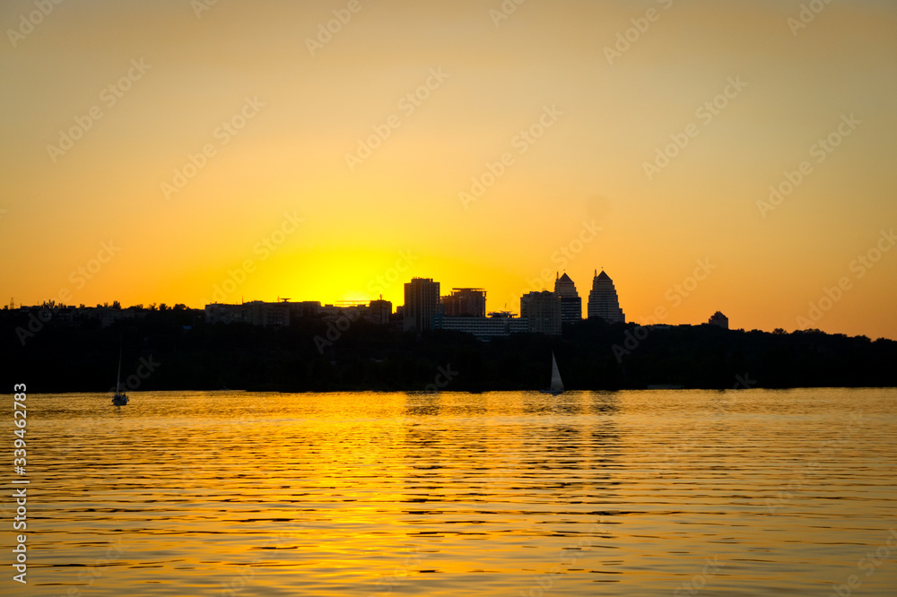 .Sunset over the river against the backdrop of the cityscape.