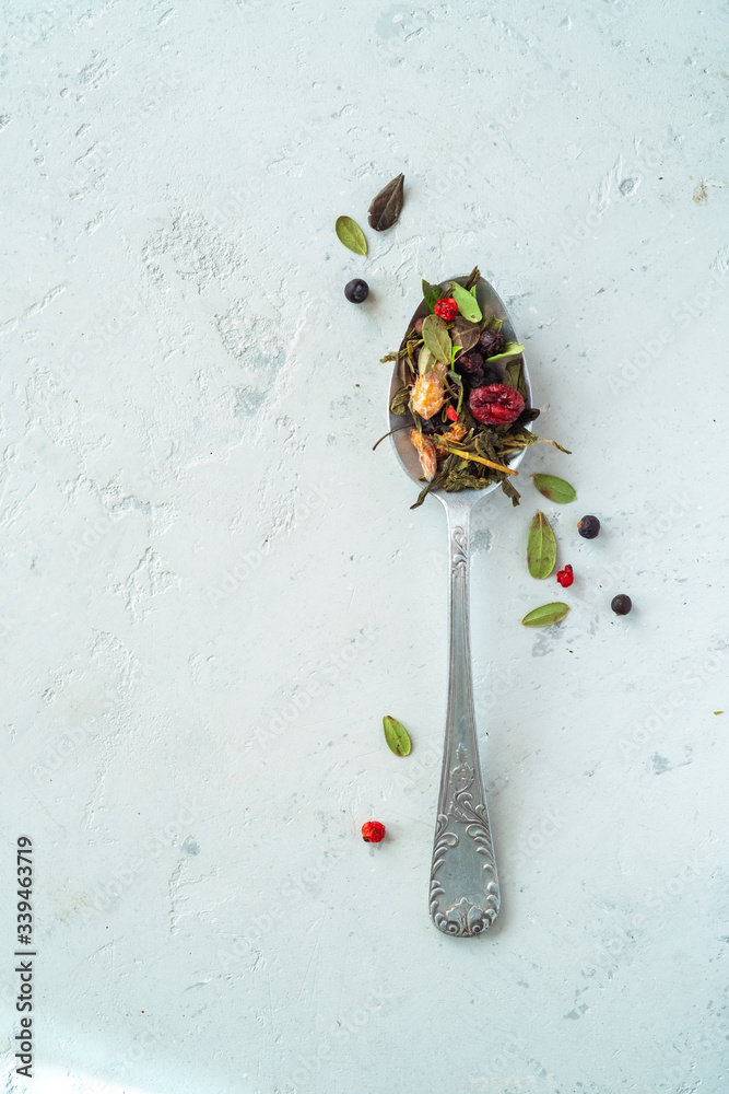 Dried herbal tea with berries on a teaspoon, top view and copy space Dried herbal tea with berries on a teaspoon, top view and copy space