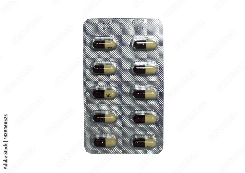 Tablet of brown and yellow capsule pills in isolated white background Tablet of brown and yellow capsule pills in isolated white background