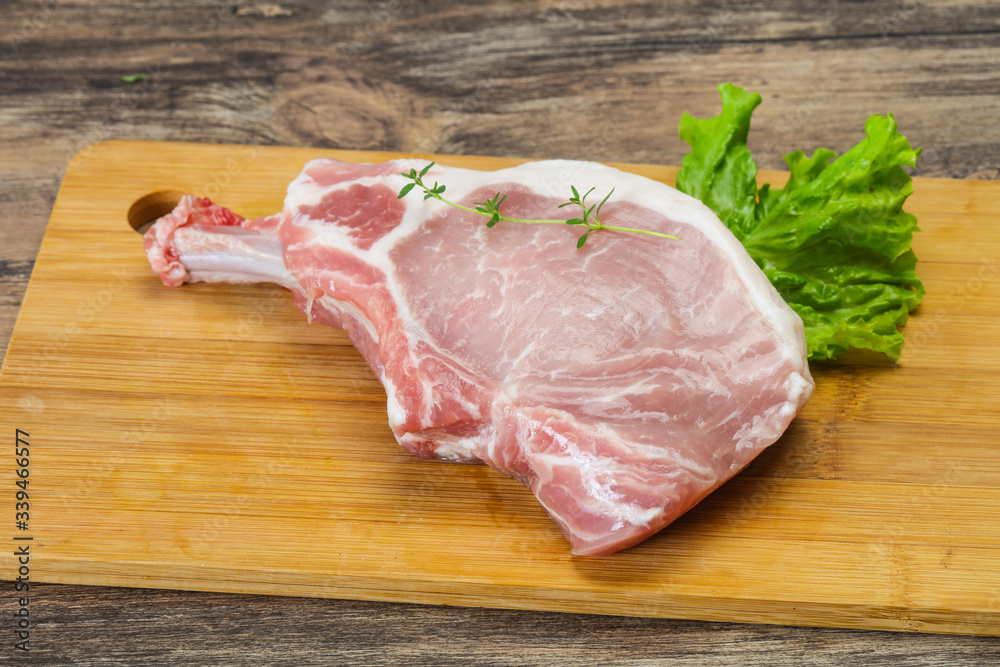 Raw pork bone steak over wooden