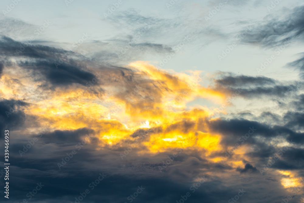 Dramatic and moody yellow, purple and blue cloudy sunset sky. Abstract nature background