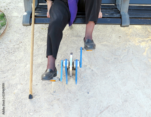 Older woman pedaling in an outdoor gym