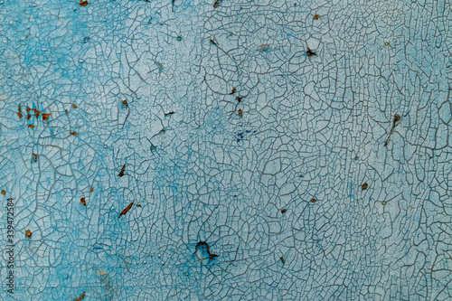 Old blue wall with scratches and cracks photo
