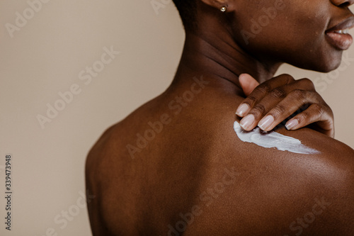 African woman applying lotion
