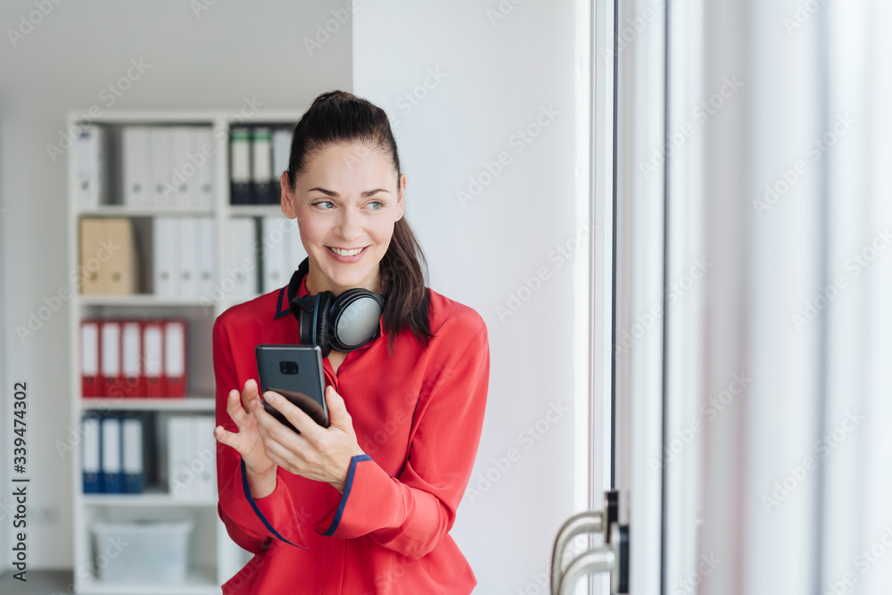 Young pretty woman with headphones in office Young pretty woman with headphones in office