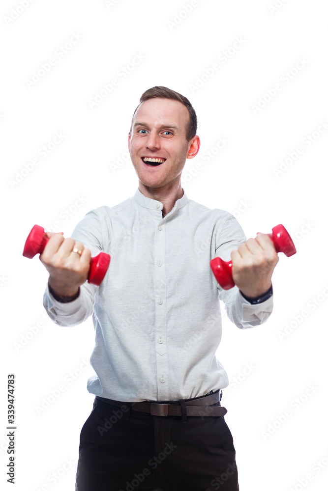Caucasian man businessman, a teacher involved in sports. He is holding a red dumbbell. He is wearing a shirt. Emotional portrait. Isolated on white background