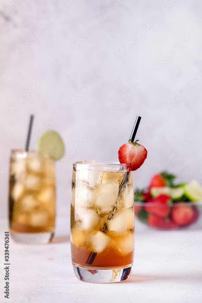Gasses of Cold Citrus and Strawberry Ice Tea Decorated with Slice of Lemon and Strawberry Healthy Summer Drink Vertical Gasses of Cold Citrus and Strawberry Ice Tea Decorated with Slice of Lemon and Strawberry Healthy Summer Drink Vertical