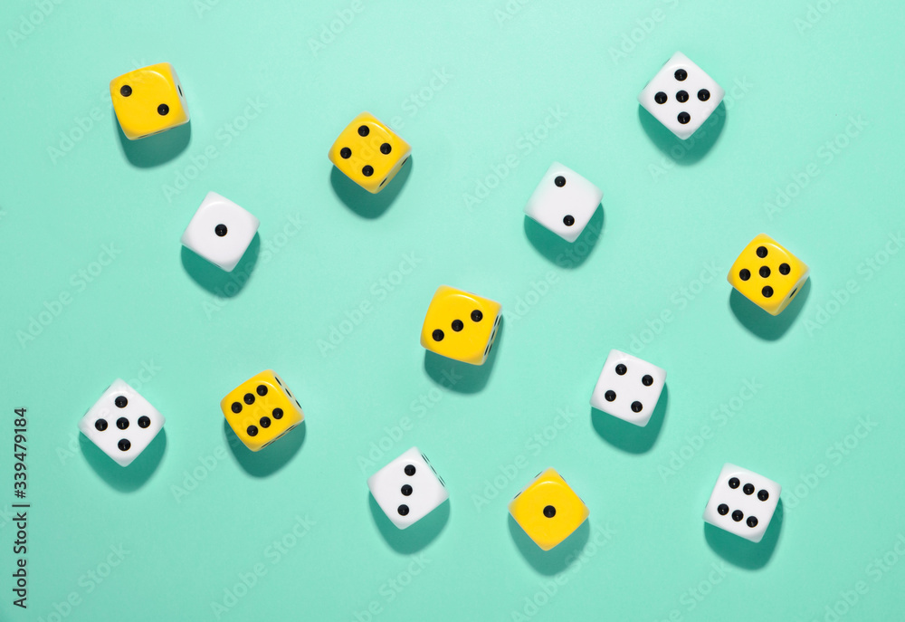 Randomly scattered yellow and white dice Randomly scattered yellow and white dice
