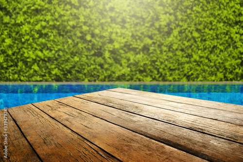 Wooden table in front with empty space for advertise display and blurred back...