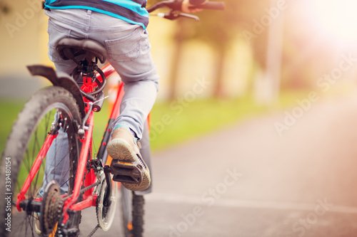 child on a bicycle at asphalt road in early morning