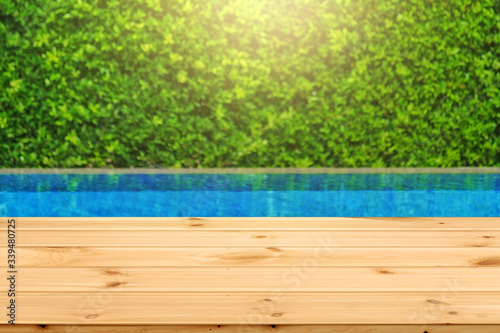 Wooden table in front with empty space for advertise display and blurred back...