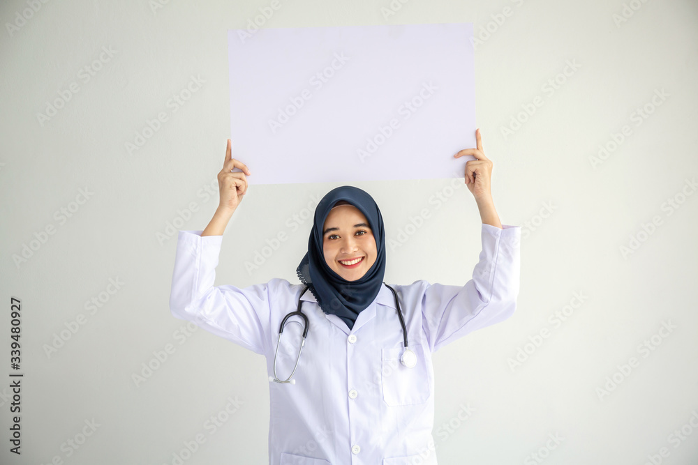 Young Arab Muslim doctor women smile showing on isolate card white background concept for Islam people working in medical hospital health care, Modern Nurse wear hijab in pandemic business service. Young Arab Muslim doctor women smile showing on isolate card white background concept for Islam people working in medical hospital health care, Modern Nurse wear hijab in pandemic business service.