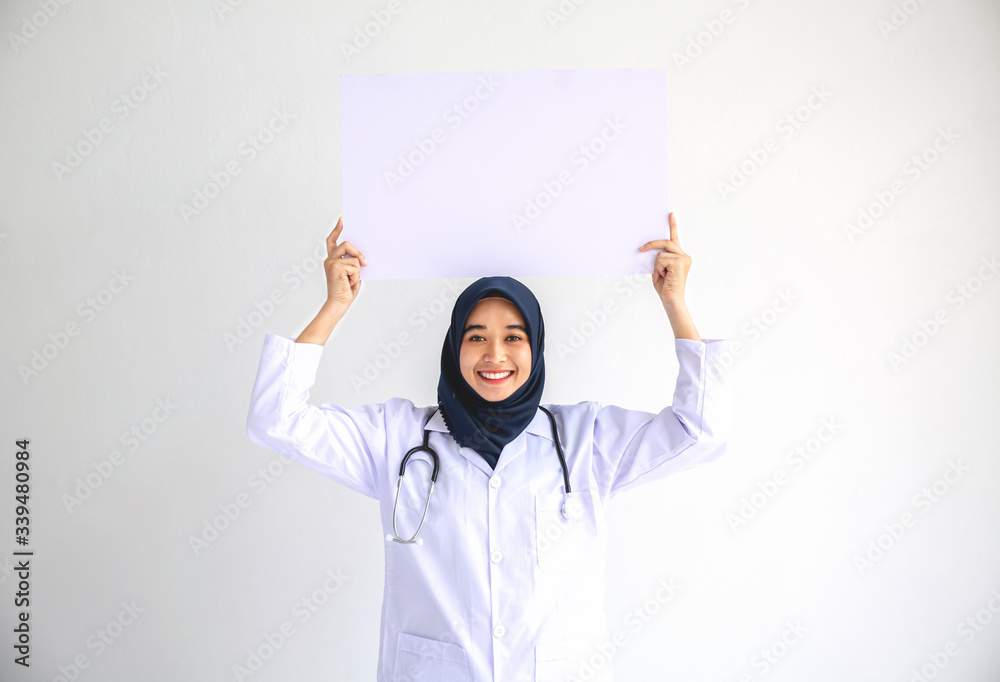 Young Arab Muslim doctor women smile showing on isolate card white background concept for Islam people working in medical hospital health care, Modern Nurse wear hijab in pandemic business service. Young Arab Muslim doctor women smile showing on isolate card white background concept for Islam people working in medical hospital health care, Modern Nurse wear hijab in pandemic business service.
