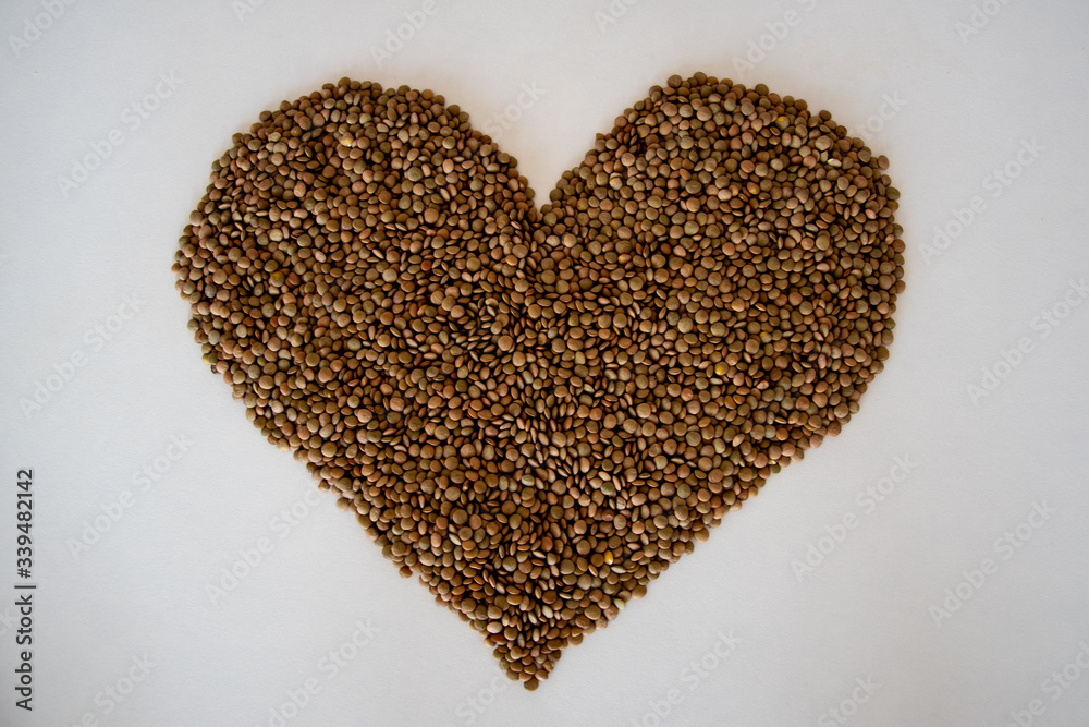 brown lentils on white surface heart shaped brown lentils on white surface heart shaped