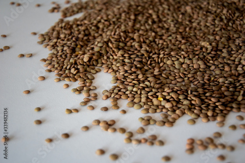 brown lentils on white surface