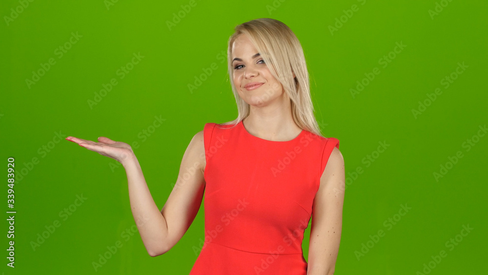 Lady in red on green screen background shows her hand Lady in red on green screen background shows her hand