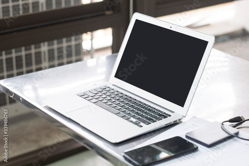 Laptop computer and mobile phones used to work at home. Use internet network To communicate with the office Placed on the table