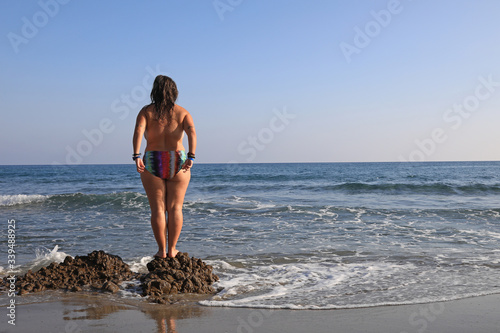 mujer joven haciendo yoga en la playa toples almería 4M0A6117-as20 photo