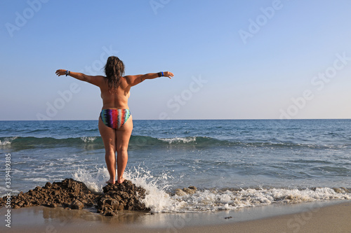 mujer joven haciendo yoga en la playa toples almería 4M0A6140-as20 photo