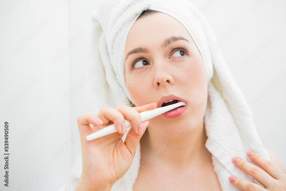 The girl in the bathroom brushes her teeth The girl in the bathroom brushes her teeth