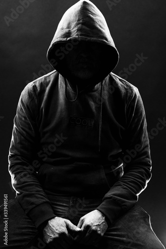 Принти на полотні a shady figure that could represent a criminal, a hacker, ambiguity and duplicit