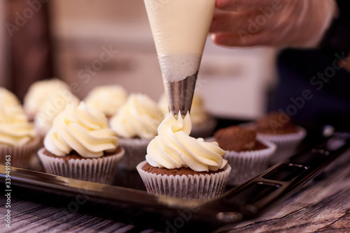 Chocolate cupcakes with a swirl of cream close-up. Selective focus.