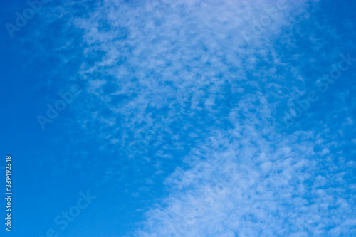 Cirrocumulus clouds in the blue sky. Natural background with copy space for text.