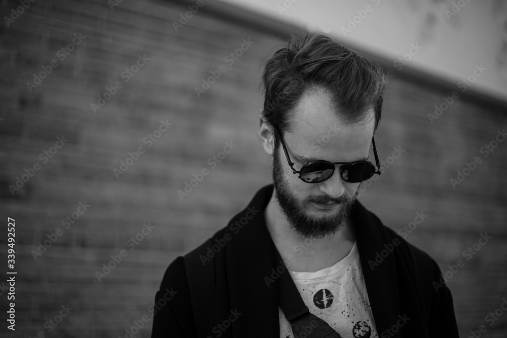 Fototapeta premium A young handsome man. Street style demonstrate 