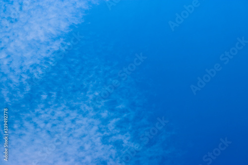 Cirrocumulus clouds in the blue sky. Natural background with copy space for text.